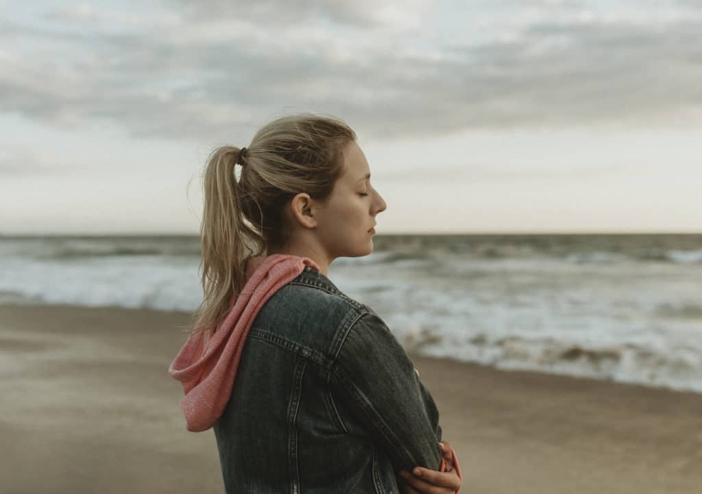 woman on beach having insight