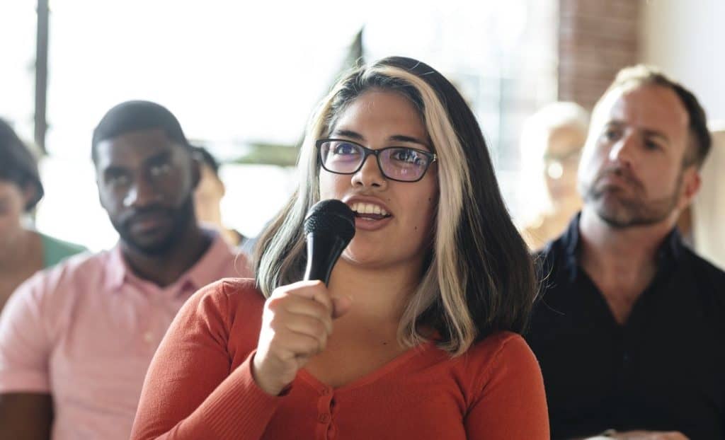 woman using voice to challenge the status quo