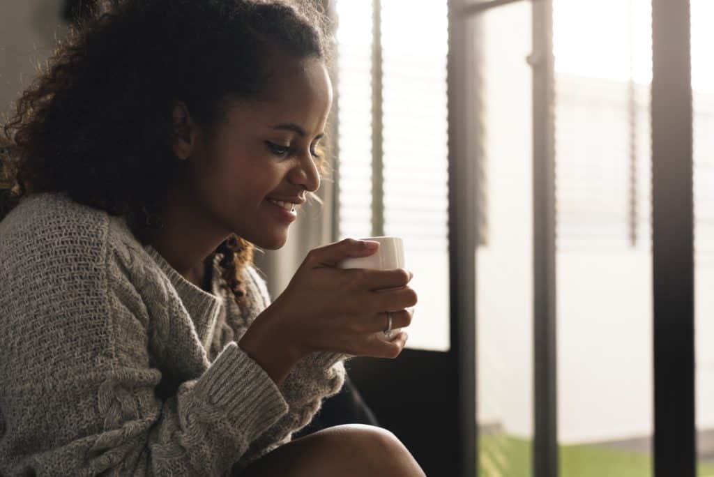 woman sips tea and feels peace