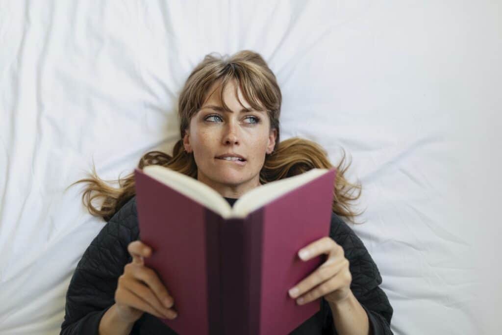 Woman reads book and contemplates response