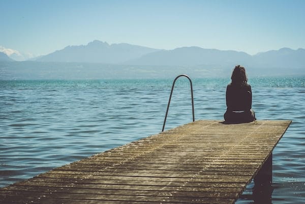 Suffering person at end of dock by water