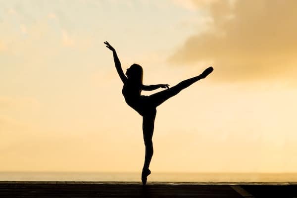 Ballerina stretching at beach