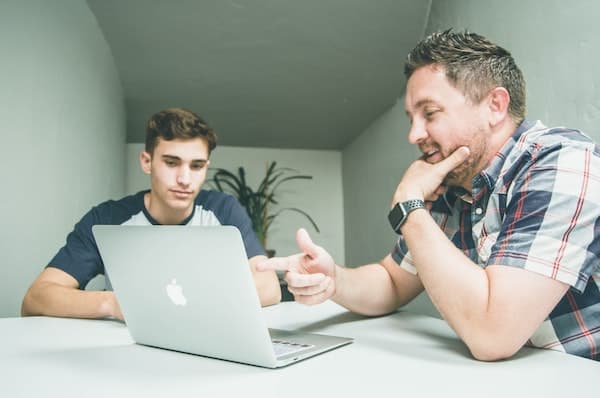 mentor helping younger person sustain goal