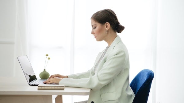 Woman investing on laptop