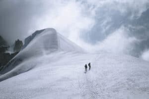 Mountain climbers walk toward the peak.