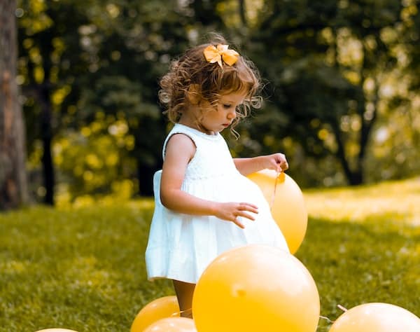 Young child with balloon regrets