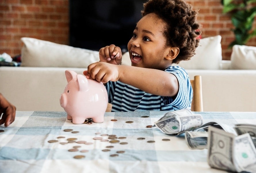 toddler with piggy bank