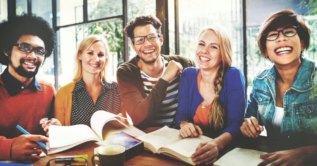 people smiling with books