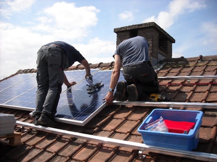 men installing solar panels