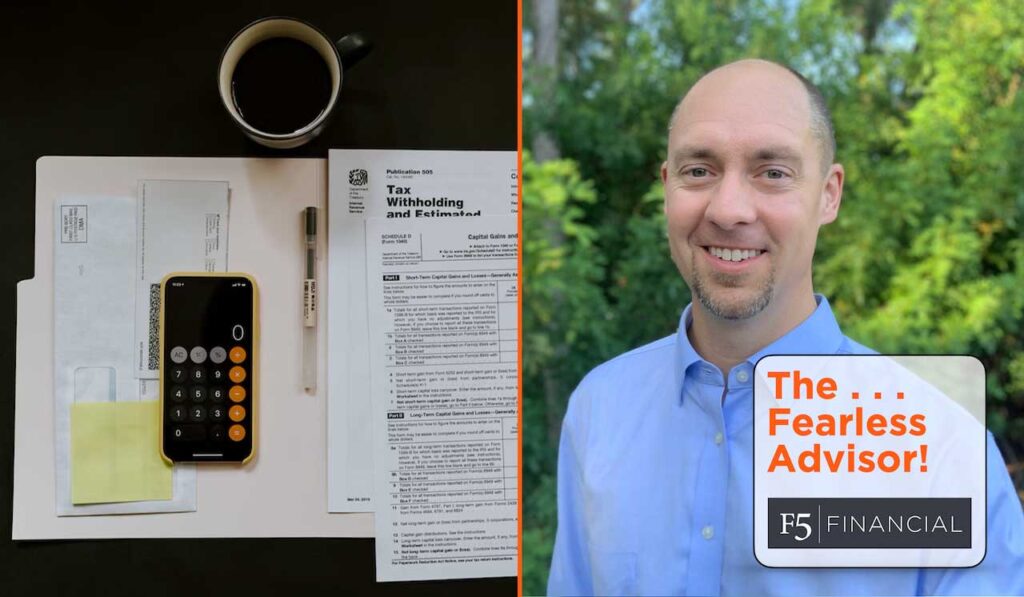 Advisor Josh Duncan next to tax papers, a calculator, and pen.