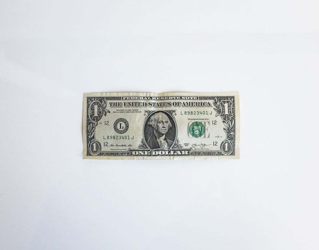 One dollar bill sitting on a white background