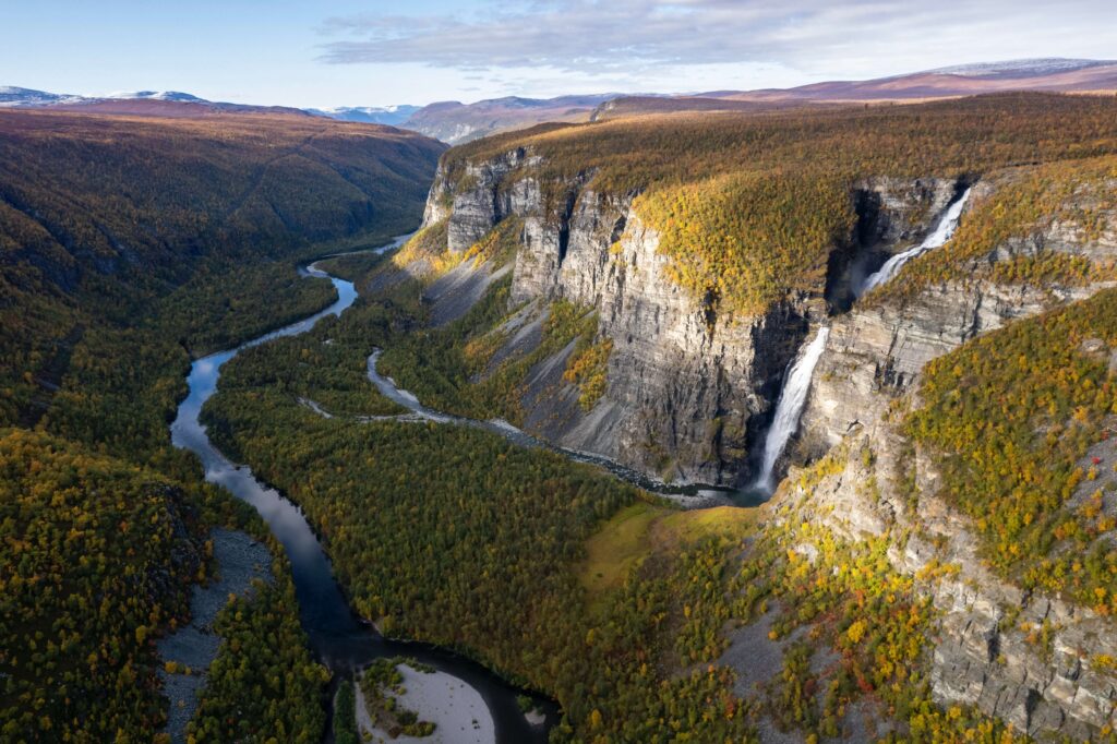 Looking down to a river meandering through a mountain range.