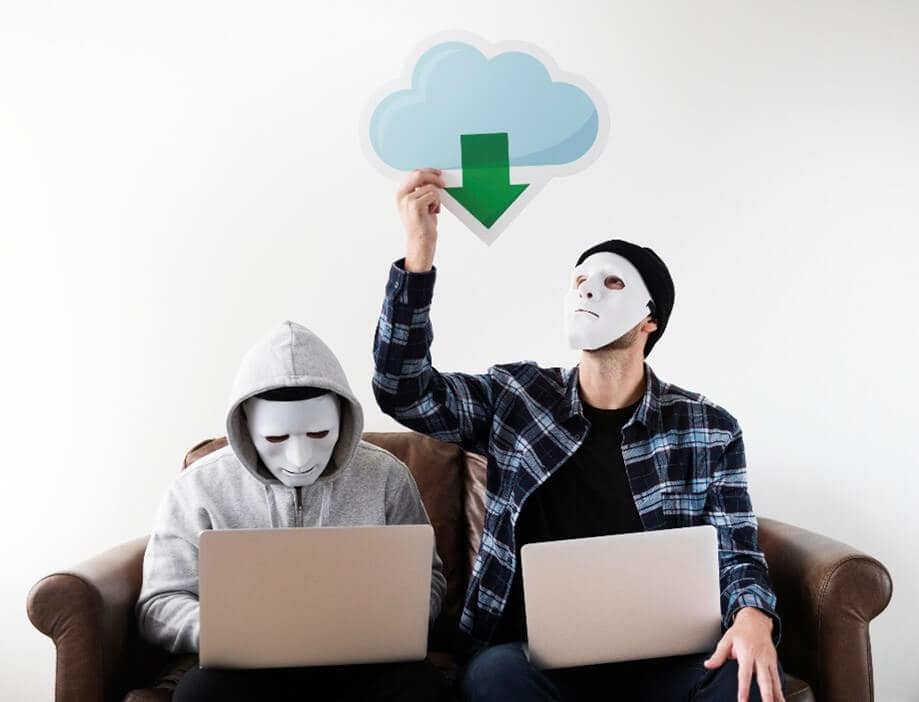 Men in masks in front of computers