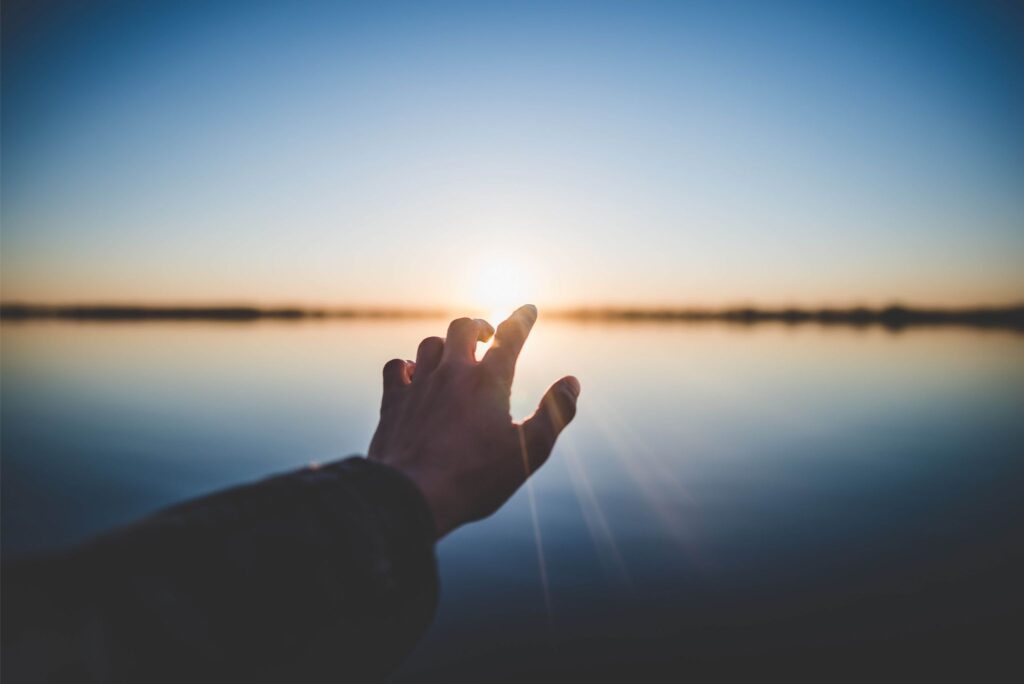 Hand Reaching Out To The Distance